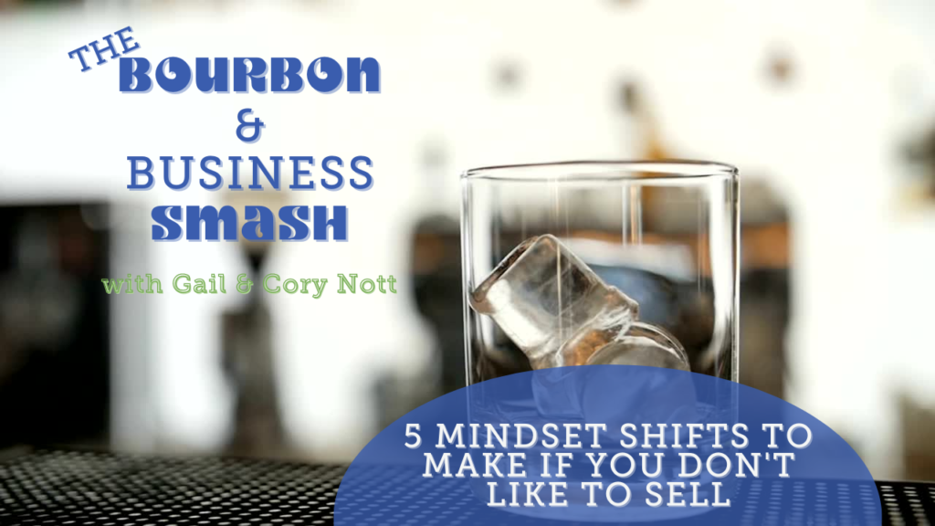 A glass of bourbon, with text 5 Mindset Shifts to Make if You Don't Like to Sell